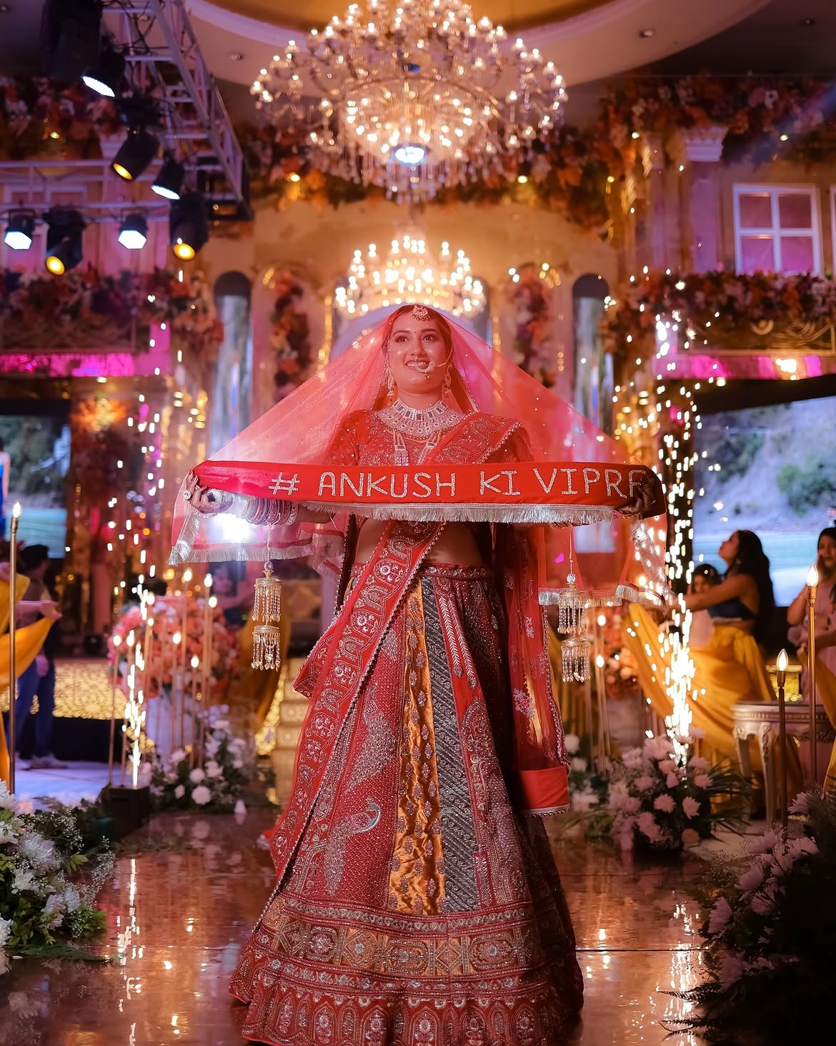 A bride making her entry under a phoolon ki chadar amid cold sparklers